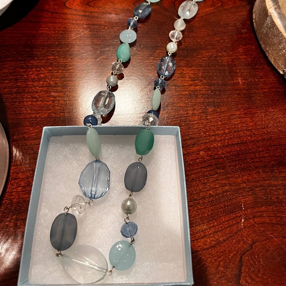 Long beaded strand necklace. Teal, blues, clear beads
